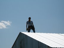 Tracy standing on the roof peek